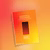 A photo of the booklet, 'An Exercise in Worldmaking', on top of a orange gradient background.