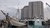 Harbour area with sailing boat in foreground and high-rise tower blocks in background