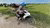 Vietnamese motorcycle rider next to a green field