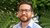 Portrait of Juan David Parra Heredia in light blue shirt with white stripes
