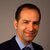 Samer Srouji sports a smile and wears a black suit