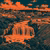 Stylized duotone orange waterfall in rocky canyon with distant city skyline