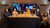 The speakers and organizers posed around a table for a photograph to celebrate the end of Research Insights Live