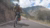 Screenshot of person on motorbike on mountain road