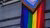 LGBTQIA flag hanging down from window