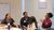 Four conference participants laughing together