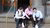 Three ISS students sitting on the stairs of ISS building