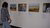 Rural Women's Assembly (RWA) seed guardians exhibition - person looking at photos on wall