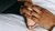 In this photo, a woman touches the foot of a newborn baby