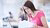 Girl with laptop and paper work with brown hair and pink shirt