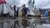 Congolese women and girls gather water outside of campus