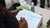 Writing 'self organization of workers' on paper