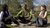 three students seating in the park