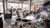 People working under a wooden roof putting coal into sacks