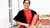 Women stands with her PhD diploma in hand