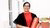 Women stands with her PhD diploma in hand