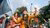 A protester in Bangladesh wearing an orange dress and waving the Bangladeshi flag