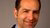 Samer Srouji sports a smile and wears a black suit