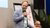 Oane Visser in light blue blazer holding microphone at conference, panelist seated behind him