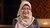 Nurul Indarti wearing peach-coloured headscarf and patterned shirt