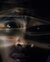 Close-up of man's face overlayed with dramatic light streaks and warped water reflections