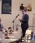 HE Faiyaz Murshid Kazi in suit reading from papers at a microphone before seated audience in conference room.