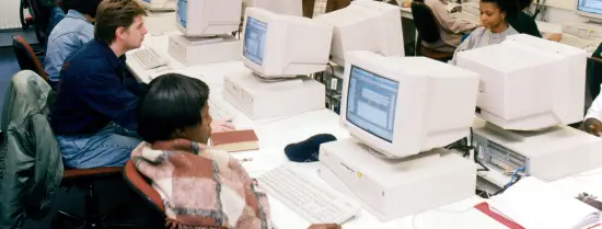 ISS students in computer room - 1980s