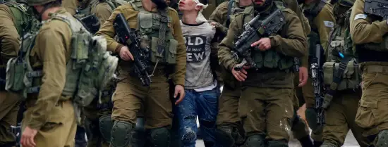 © Israeli forces detain 16-year-old Fawzi al-Juneidi during confrontations between Palestinians and the army in the West Bank city of Hebron that followed protests against Trump’s recognition of Jerusalem as the capital of Israel, 7 December. The boy, who was beaten by soldiers during his arrest, was released on bail 20 days later. Wisam Hashlamoun APA images © 2019 Electronic Intifada