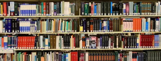 Book shelves full of books - Creating Postgraduate Collaborations