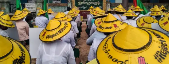Myanmar - people sitting in yellow hats