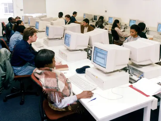 ISS students in computer room - 1980s